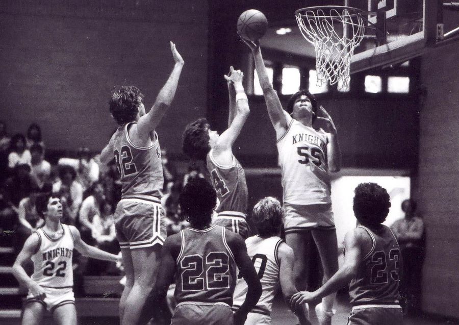 Menlo's Eric Reveno (55) goes for a lay-in as Matt Halprin (22) and John Paye (10 look on. 